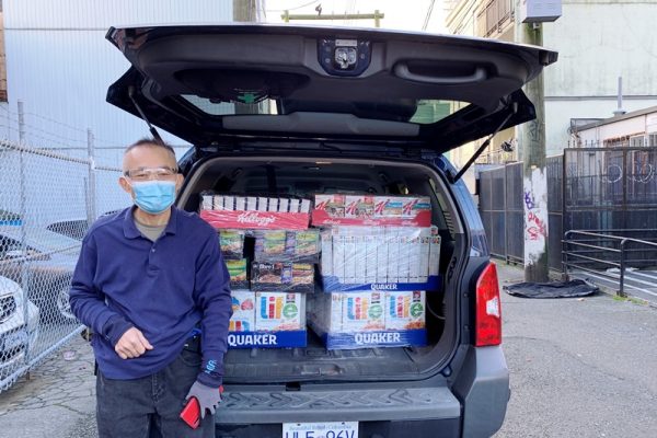 Lotus Light Volunteer Helps Loading Donation
