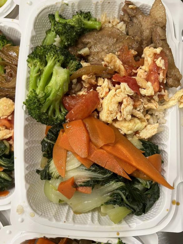 Kitchen volunteer bought pork chops and seasonal vegetables to serve people in need at volunteers’ own expense.